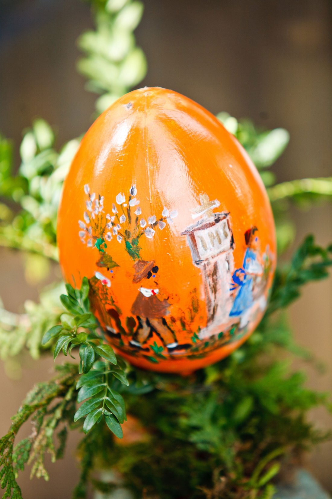 Orange Easter egg painted with figures
