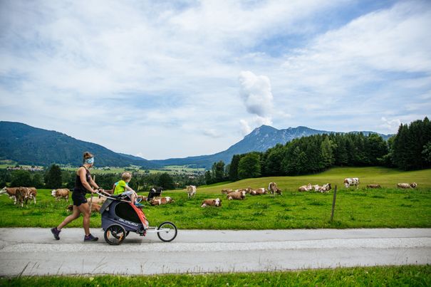Family with a pushchair on the way to the Kesselalm in Chiemgau
