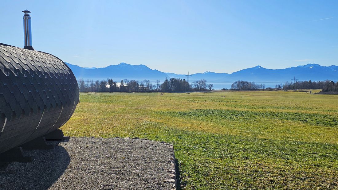 Outdoor sauna area with views of Lake Chiemsee and the Alps