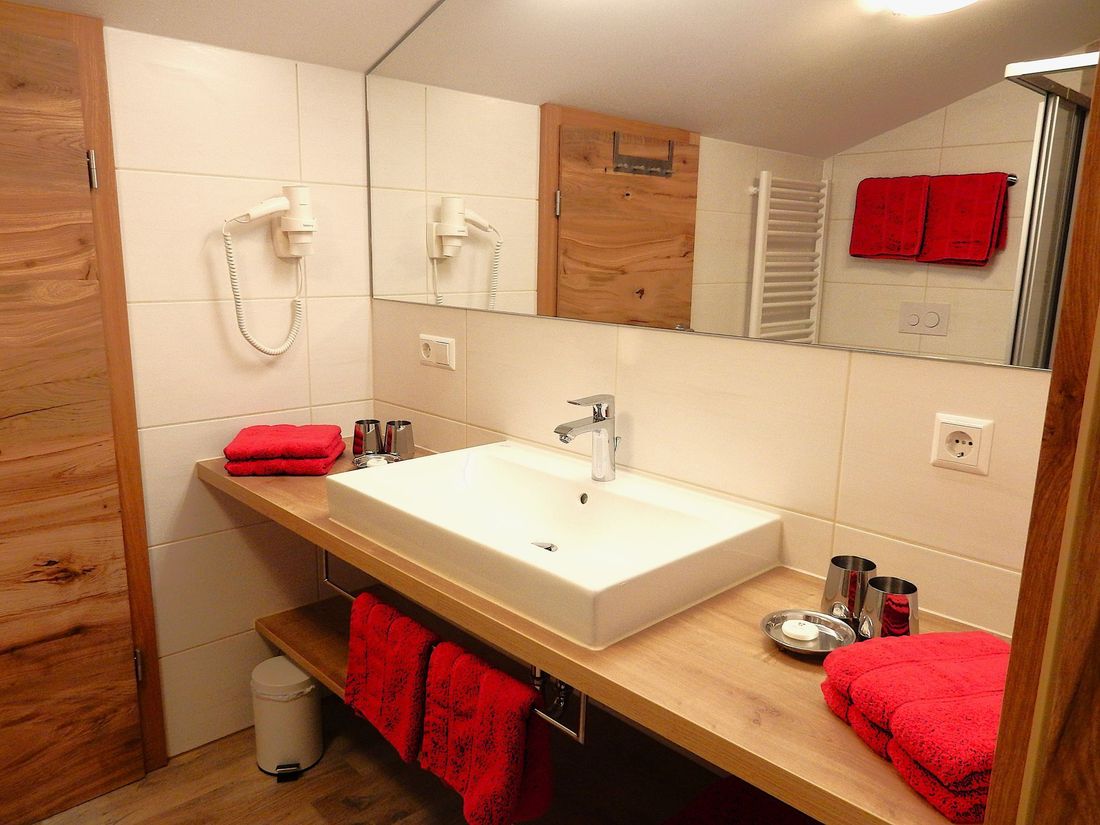 Living example: modern bathrooms with cozy towels, bath towels, and hair dryers await you in our “Guesthouse Schönfeld”...