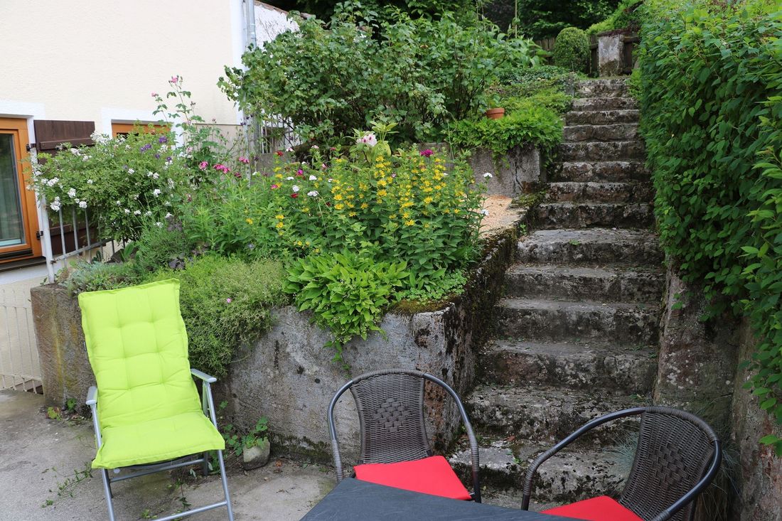 Stepped beds and stone stairs to the terrace and entrance to the main house
