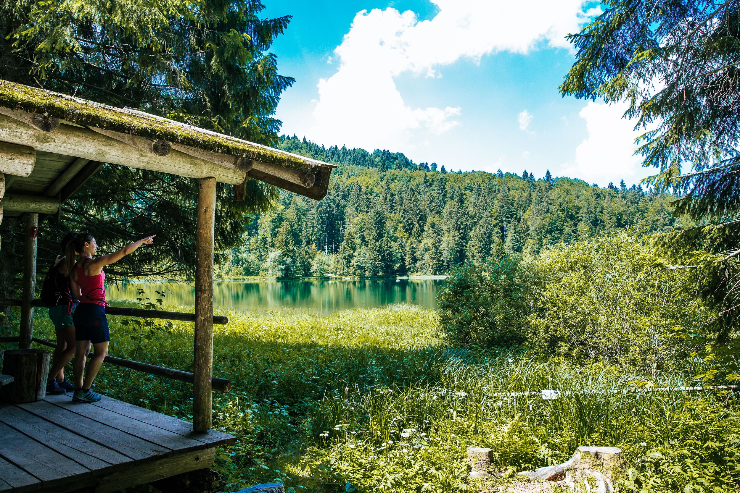 Two women look out over the Frillensee in Inzell